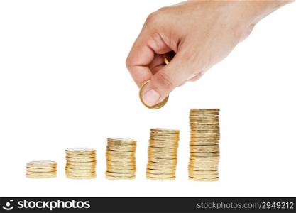 Golden coin stacks isolated and hand holding coins as saving concept