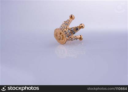 Golden color crown model with pearls on white background