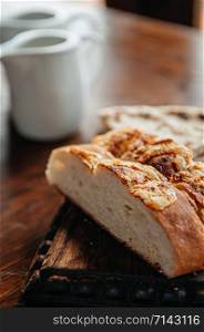 Golden crispy skin baked potato bread on wooden table for breakfast close up bakery bun image