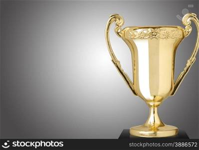 Golden cup trophy on gray background