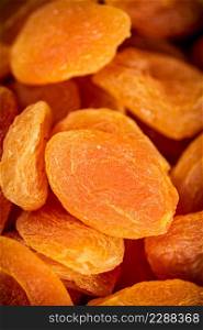 Golden dried apricots. Macro background. The texture of dried apricots. High quality photo. Golden dried apricots. Macro background.
