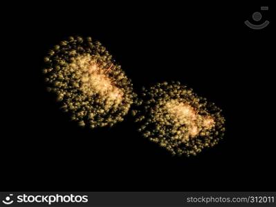 Golden exploded fireworks display, isolated on black background