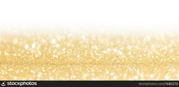Golden festive glitter background with defocused lights , white copy space. Festive glitter background