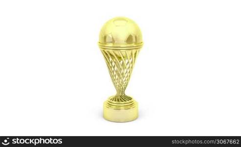 Golden football trophy rotates on white background
