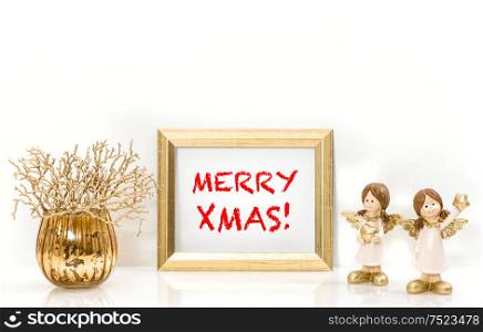 Golden frame and Christmas decorations Angels. Greeting card concept with sample text Merry Xmas!