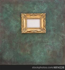 Golden frame on grungy wall background. Stone texture