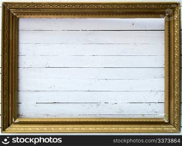 Golden frame on white wooden a plank