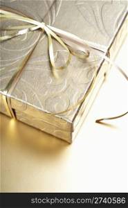 Golden gift box with golden ribbon