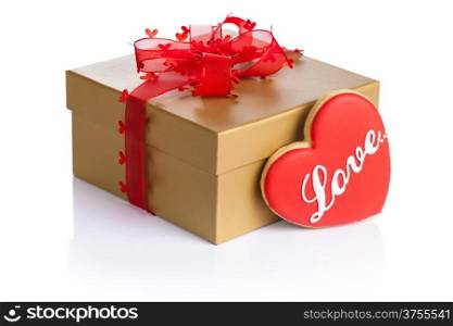 Golden gift box with love cookie in shape of heart on white background. Composition for Valentines Day