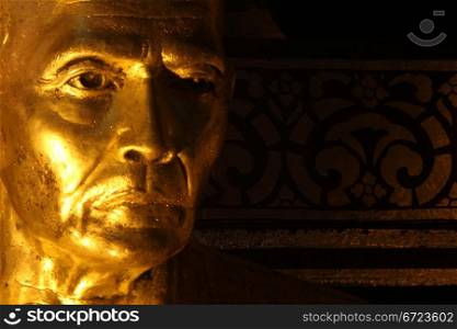 Golden head of monk in the dark temple, Chiang Mai, Thailand