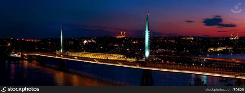 Golden Horn metro bridge illuminated at night in Istanbul, Turkey