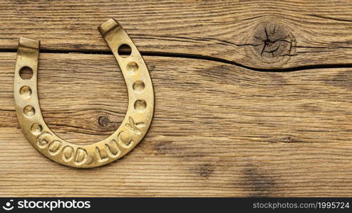 golden horseshoe wooden background