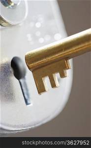 Golden key and padlock, close-up