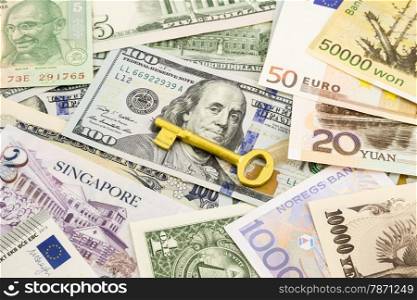 golden key and world currency money banknotes, idea for success business