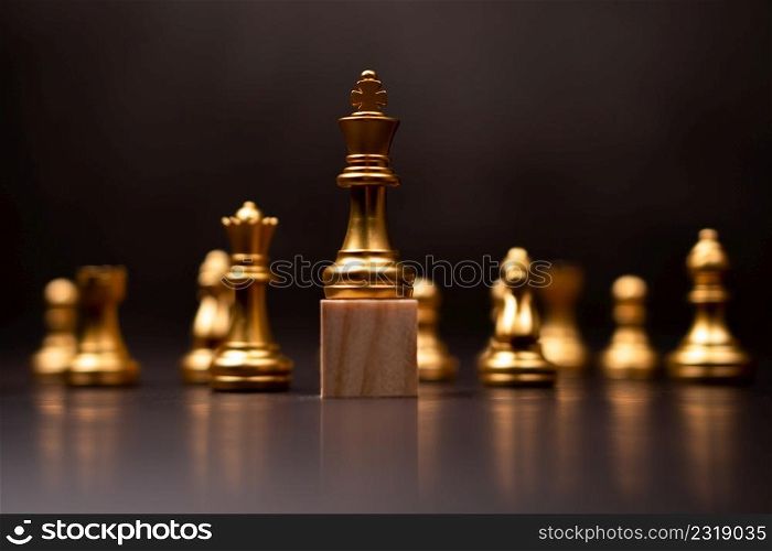 Golden king chess standing on a wooden stand. The concept of Leaders in good organizations must have a vision and can predict business trends and assess competitors