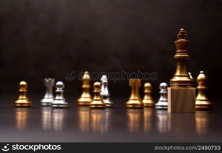 Golden king chess standing on a wooden stand. The concept of Leaders in good organizations must have a vision and can predict business trends and assess competitors