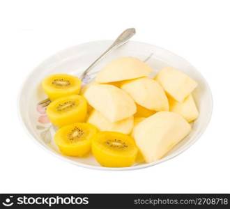 Golden kiwi fruit and sliced apple with fork in plate