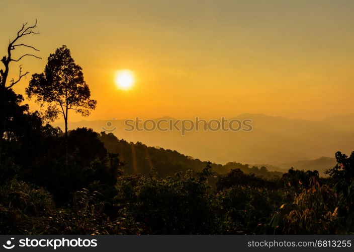 Golden light of sunset over mountain range from Panoen Thung scenic point at Kaeng Krachan National Park Phetchaburi province in Thailand