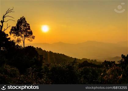 Golden light of sunset over mountain range from Panoen Thung scenic point at Kaeng Krachan National Park Phetchaburi province in Thailand