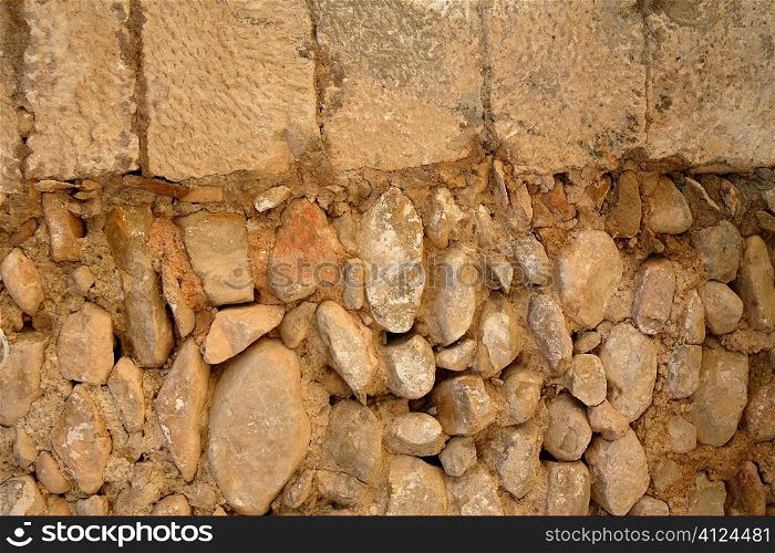 Golden masonry stone wall from old building contruction facade