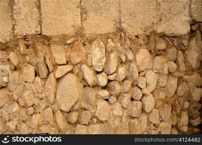 Golden masonry stone wall from old building contruction facade