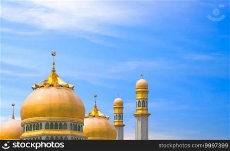 Golden mosques dome and towers against blue sky, symbolic background of islamic religion with copy space for text Ramadan Kareem, Eid al adha, Eid al fitr, Mubarak, Muharram