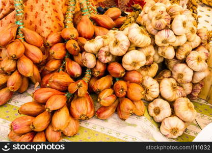 Golden onions, shallots and garlic in strings.