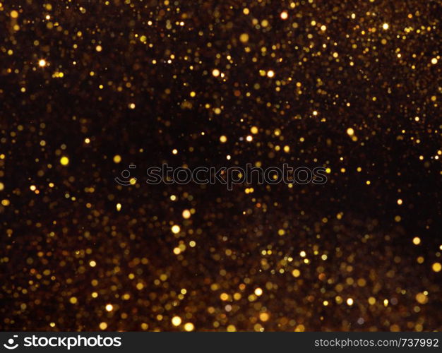 Golden overlay background of golden lights with bokeh effect. Includes copy space.