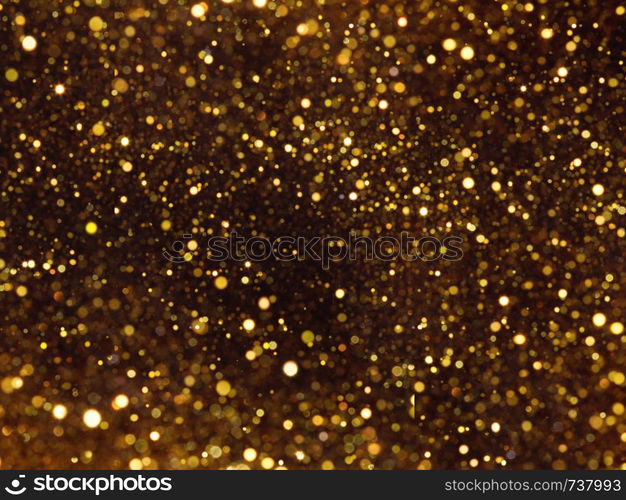 Golden overlay background of golden lights with bokeh effect. Includes copy space.