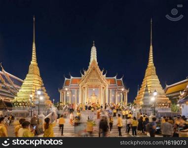 Golden pagoda at Temple of the Emerald Buddha in Bangkok, Thailand. Wat Phra Kaew and Grand palace in old town, urban city. Buddhist temple, Thai architecture. A tourist attraction at night.