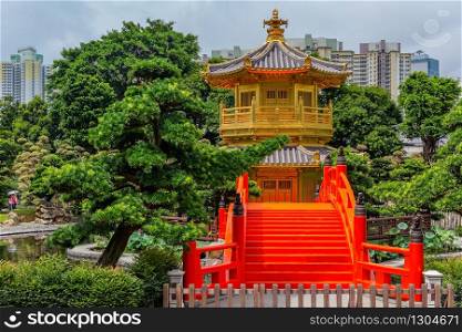 Golden pagoda of Nan Lian garden in Hong Kong city with a cloudy sky, Hongkong China