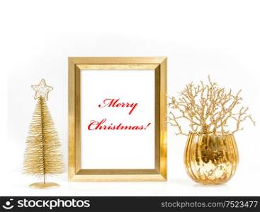 Golden picture frame and shiny christmas ornaments. Festive decoration with sample text Merry Christmas!