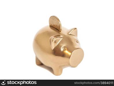 Golden piggy bank with coin isolated on white