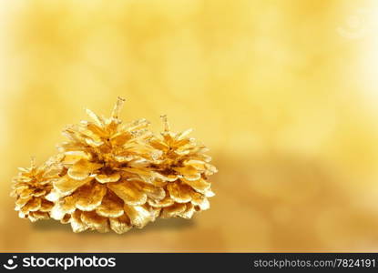 Golden pine cone isolated on white