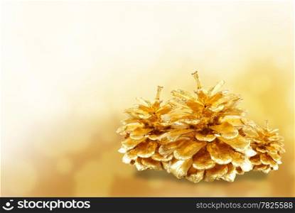 Golden pine cone isolated on white