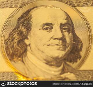 Golden Portrait of Benjamin Franklin on a one hundred dollar banknote