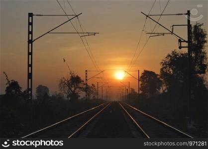 Golden railway tracks at sunrise near Pune