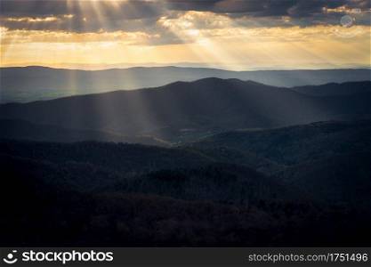 Golden rays of light shine down into the valleys of Shenandoah National Park in the Spring.