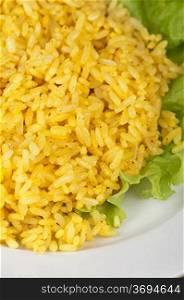 golden rice with lettuce at plate closeup