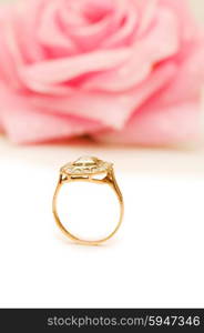 Golden ring and rose at the background