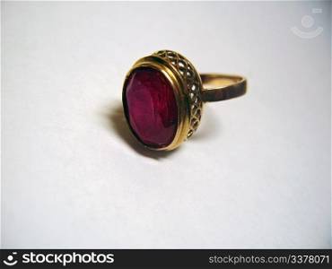 Golden ring with a red stone isolated