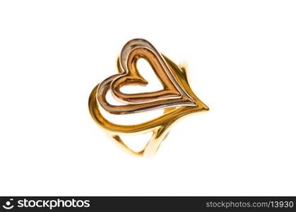 Golden ring with heart shape on the white