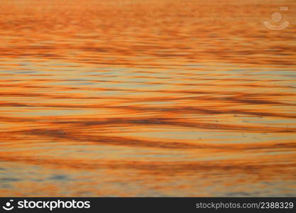 golden ripped water in the river as background