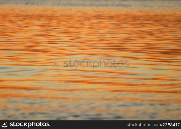 golden ripped water in the river as background
