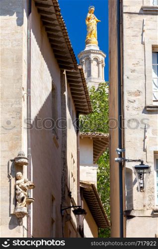 Golden sculpture of the Virgin on the bell tower of the church of the popes palace. Avignon. Provence. France.. Avignon. Golden sculpture of the Virgin on the bell tower of the popes palace.