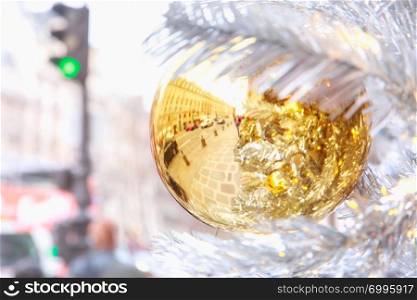 Golden shiny ball on Christmas decorated street in Paris, France. Golden Christmas ball in Paris, France
