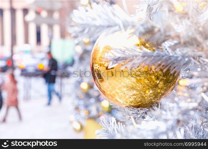 Golden shiny ball on Christmas decorated street in Paris, France. Golden Christmas ball in Paris, France