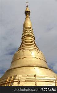 Golden Shwe Dagon stupa and dark clouds in Yangon, Myanmar