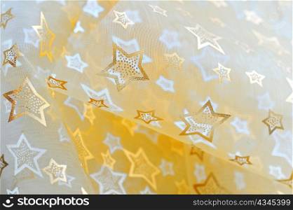Golden stars on cloth background
