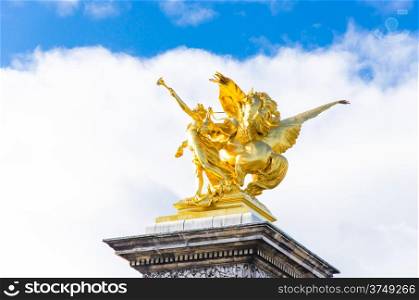 Golden statue on the bridgeAlexandre III in Paris, France.